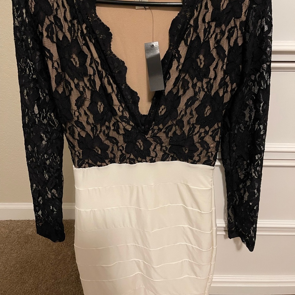 New never worn dress with tag. Black lace top. White bottom skirt. One piece